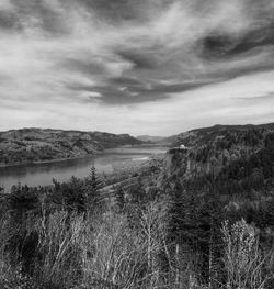 Scenic view of lake against cloudy sky
