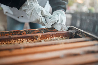 Cropped hand of man working on barbecue grill