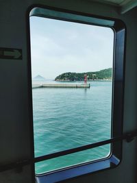 Scenic view of sea seen through window