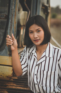 Portrait of smiling teenage girl standing outdoors