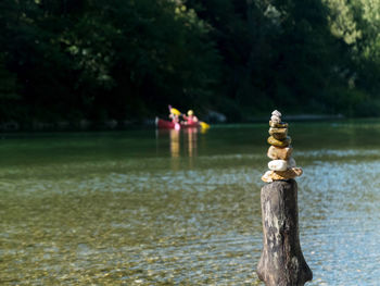 Wooden post in lake