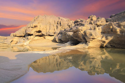 Rock formations against sky during sunset