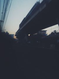 Silhouette buildings against sky during sunset