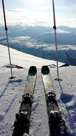 Personal perspective of ski equipment on top of mountain