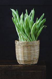 Green beans in wicker basket on table