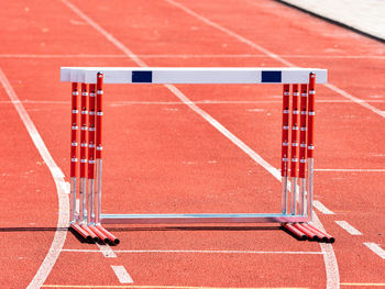 Hurdles and red running tracks in a stadion. beginning of athletic training