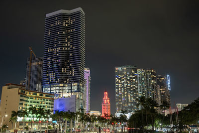 Illuminated buildings in city at night