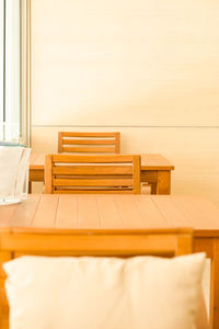 Empty chairs and table on bed against wall at home