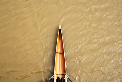 View from above on part of woman rowing single scull on river