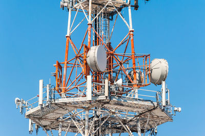 Low angle view of communications tower against clear sky