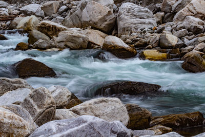 Stream flowing through rocks in sea