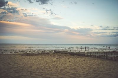 Scenic view of beach against sky during sunset