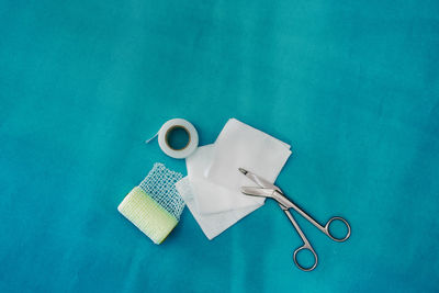 High angle view of dental equipment on blue background