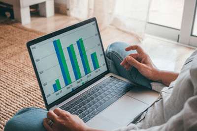 Midsection of man using laptop on table