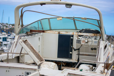 Close-up of old ship moored at sea against sky