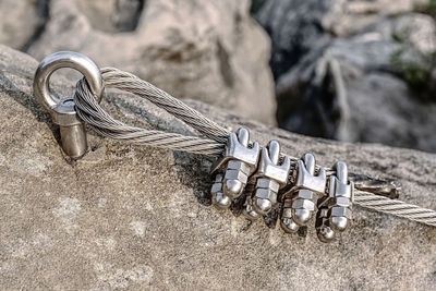 Climbing anchor or carabiner attached to the cliff rock. difficult path for climbing on via ferrata