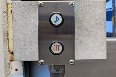 Close-up of information sign on wall