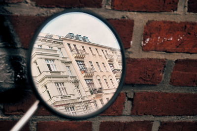 Reflection of building in side-view mirror