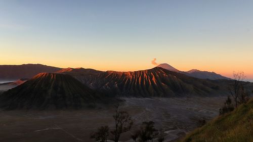 View of volcanic mountain against sky during sunset