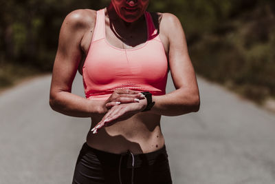 Midsection of woman standing against blurred background