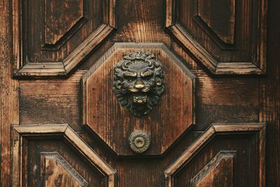 Close-up of metallic lion sculpture on door