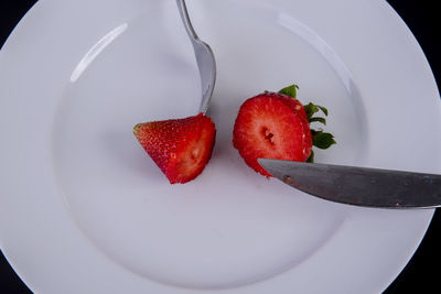 High angle view of strawberries in plate on table