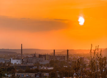 View of townscape against orange sky