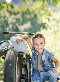 Side view of boy sitting in car