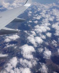 Cropped image of airplane flying over sea