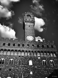 Low angle view of tower against cloudy sky