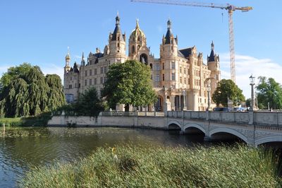 Arch bridge over river against church