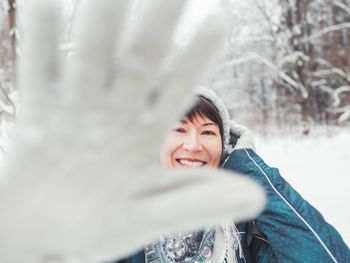 Portrait of smiling young woman in snow