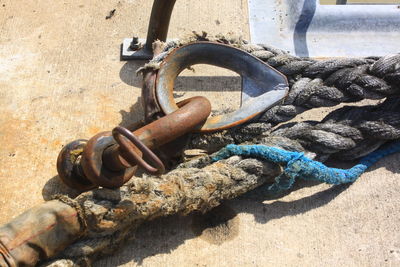 Close-up of rusty tied up on metal chain