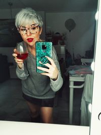 Portrait of young woman using mobile phone