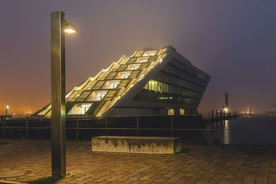 Low angle view of illuminated buildings against sky at night