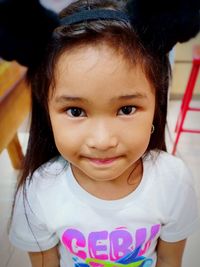 Close-up portrait of cute girl smiling