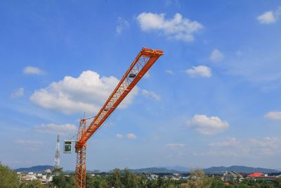 Low angle view of crane against sky