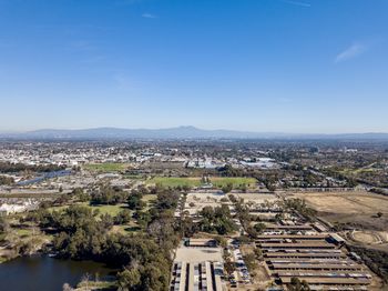 High angle view of buildings and river against blue sky