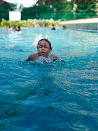 Portrait of woman swimming in pool