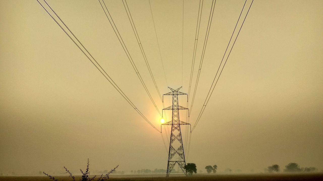 LOW ANGLE VIEW OF SILHOUETTE ELECTRICITY PYLON AGAINST CLEAR SKY