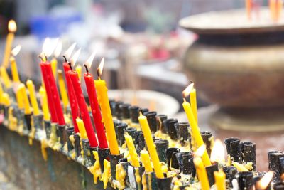 Close-up of lit candles in temple