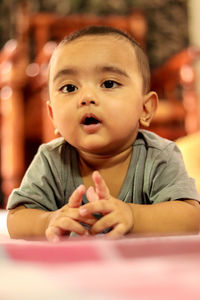 Cute 1 year old asian baby boy playing on the floor