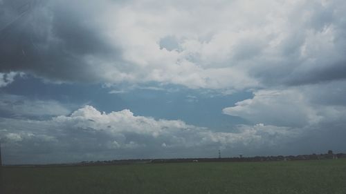 Scenic view of landscape against cloudy sky