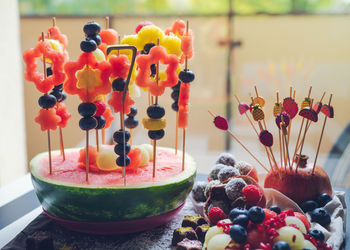 Colorful fruit dessert for a child's birthday. various shapes of fruit are put on toothpicks. 