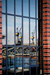 Reflection of cranes at harbor