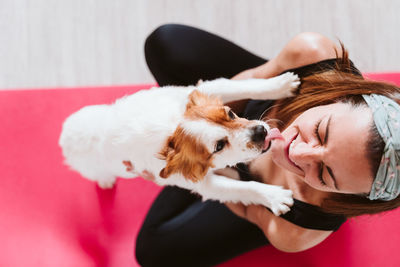 High angle view of woman with dog at home