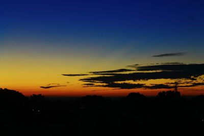 Silhouette trees against sky during sunset