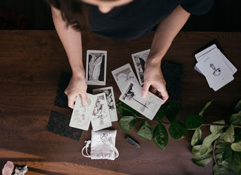 Woman handswith tarot cards at home