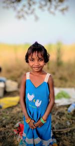 Portrait of girl standing on land