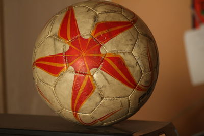 Close-up of red ball hanging on table